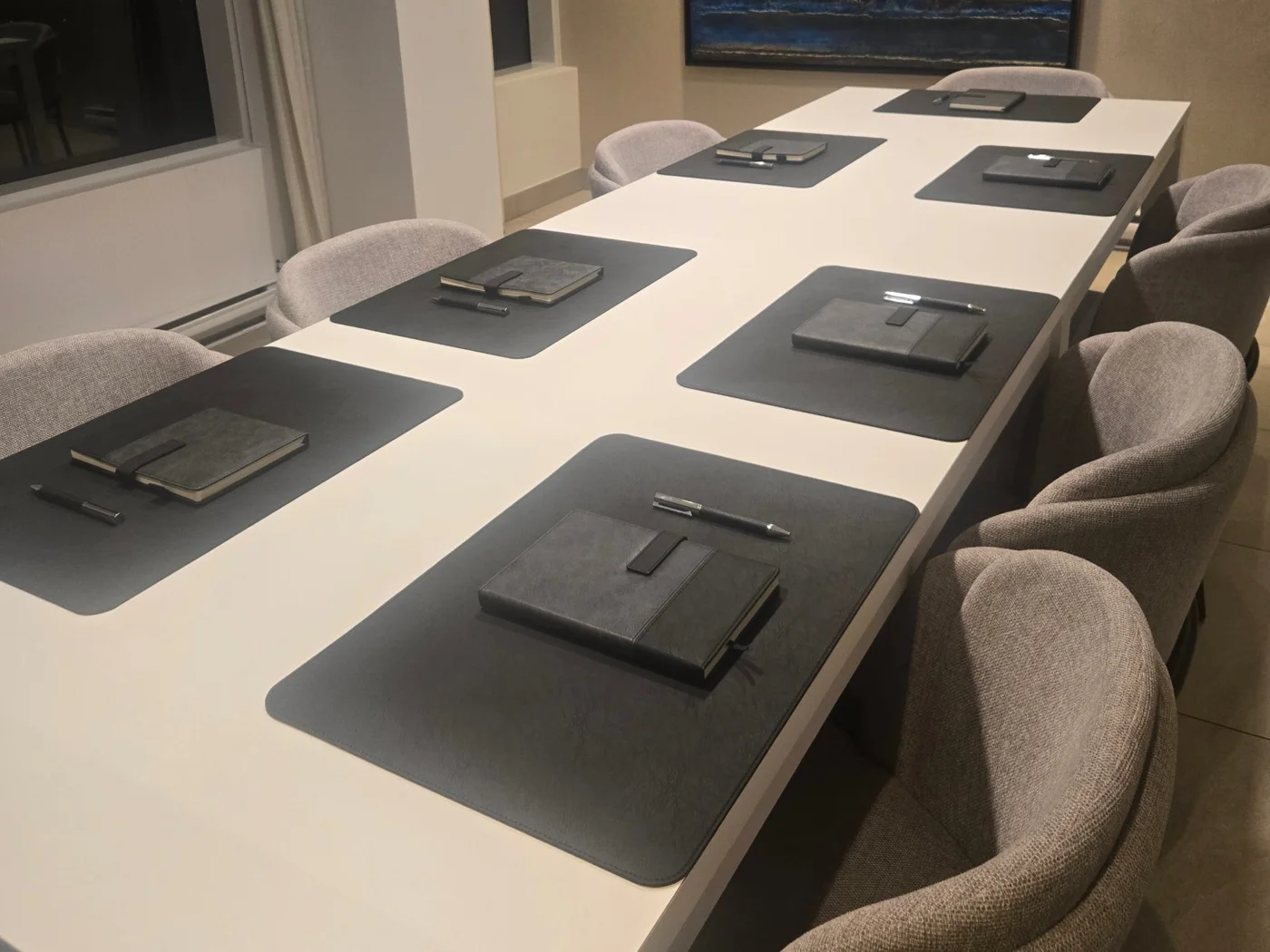Black VIP Setup on a boardroom table: desk pads, notebooks and pens at every seat